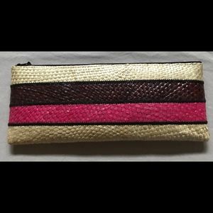 A structured clutch in woven straw.